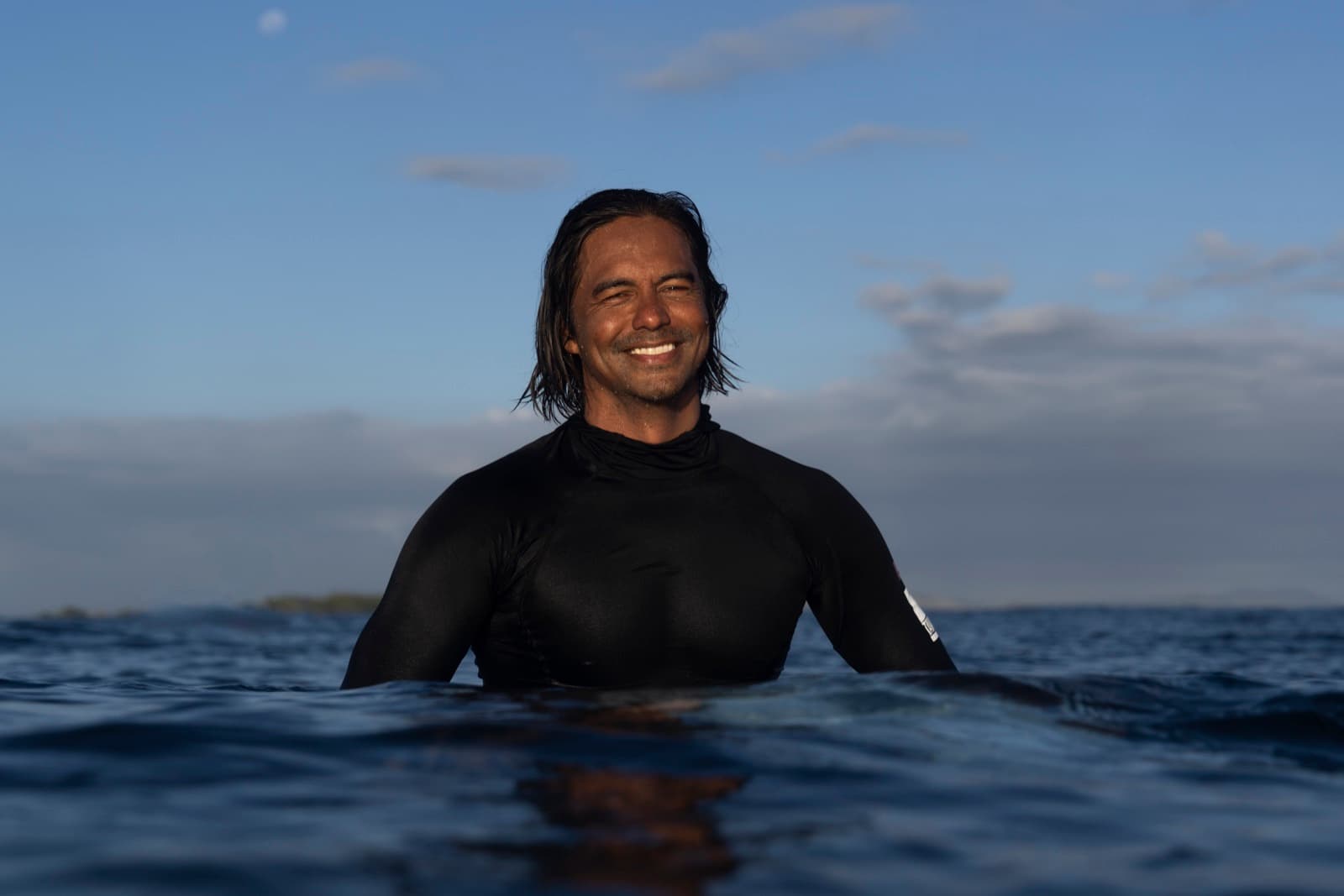 Dominic Del Rosario in the water at dusk.